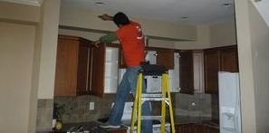 Water Damage Technician Conducting Ceiling Repair